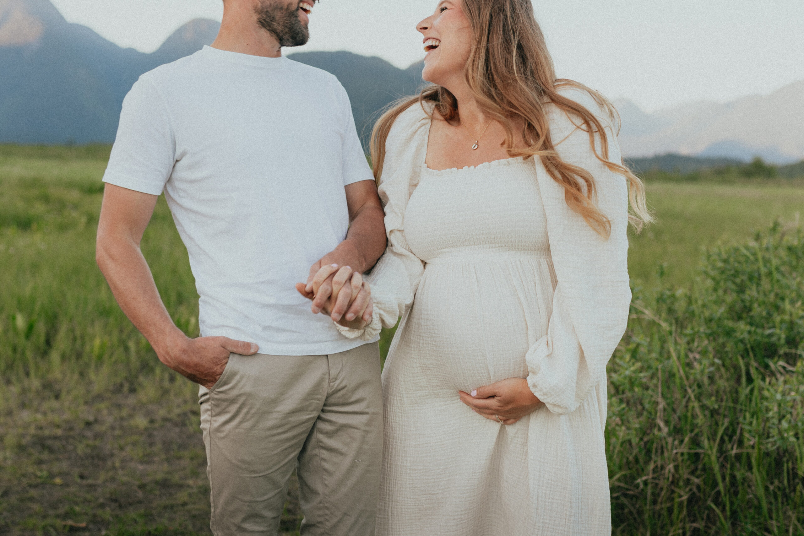 photo of a couple taken so you can see the moms baby bump and their faces are out of frame, taken in the fraser valley mountains