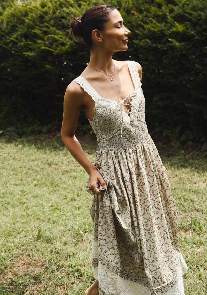 photo of a model wearing a thick tank top style dress taken outside in the grass