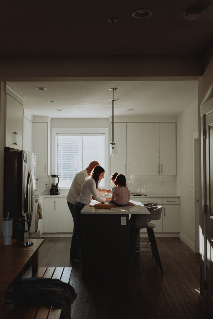 family photography photo of a family standing in their kitchen baking cookies taken in langley