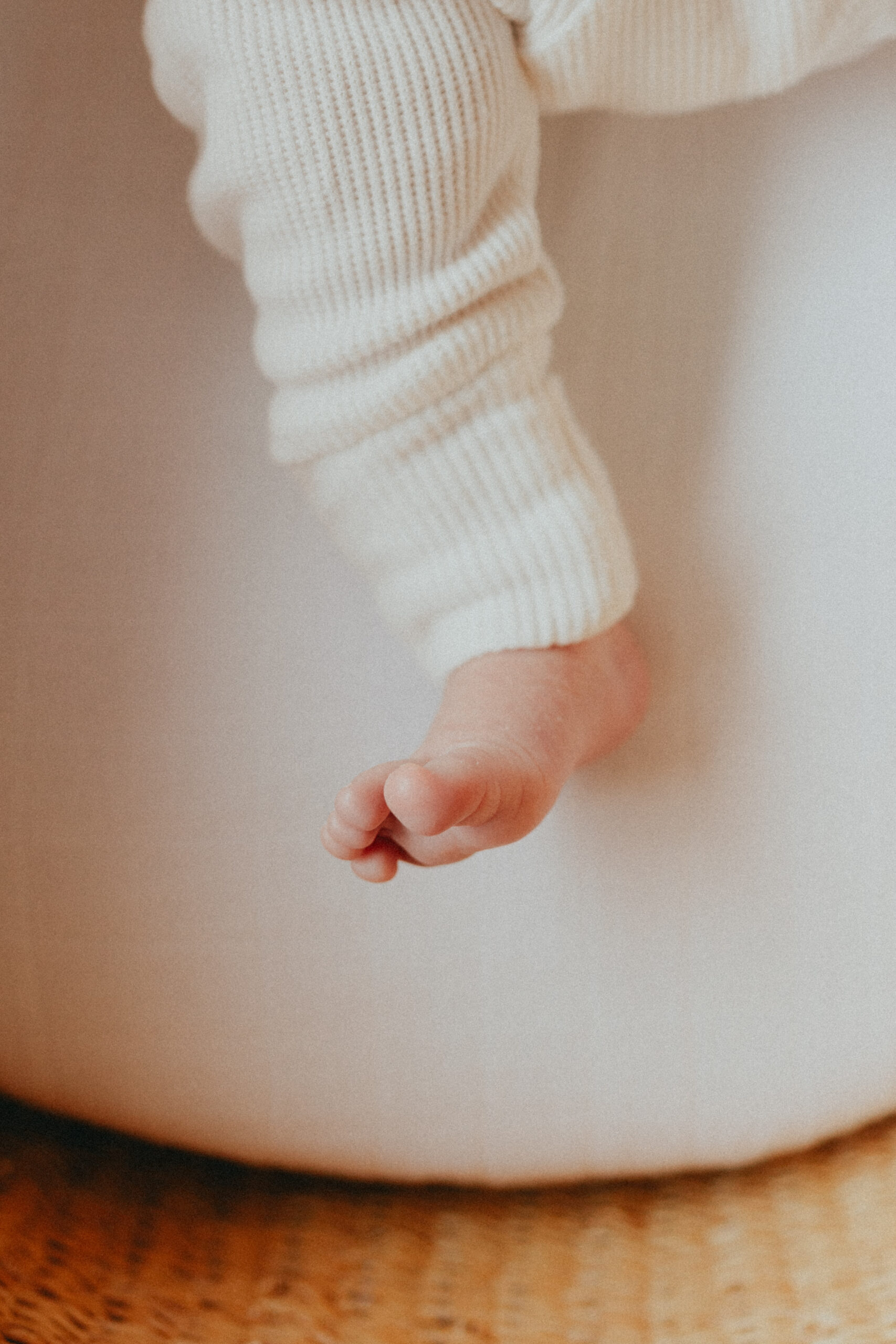 Close up photo of a baby's foot taken while they are laying in their bassinet