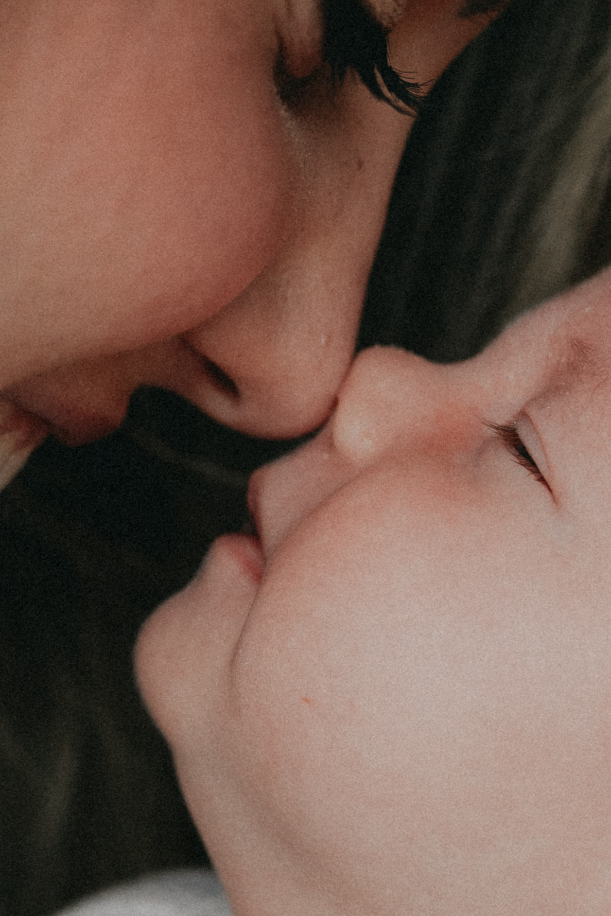 Close up photo of a mom and her newborn baby touching noses