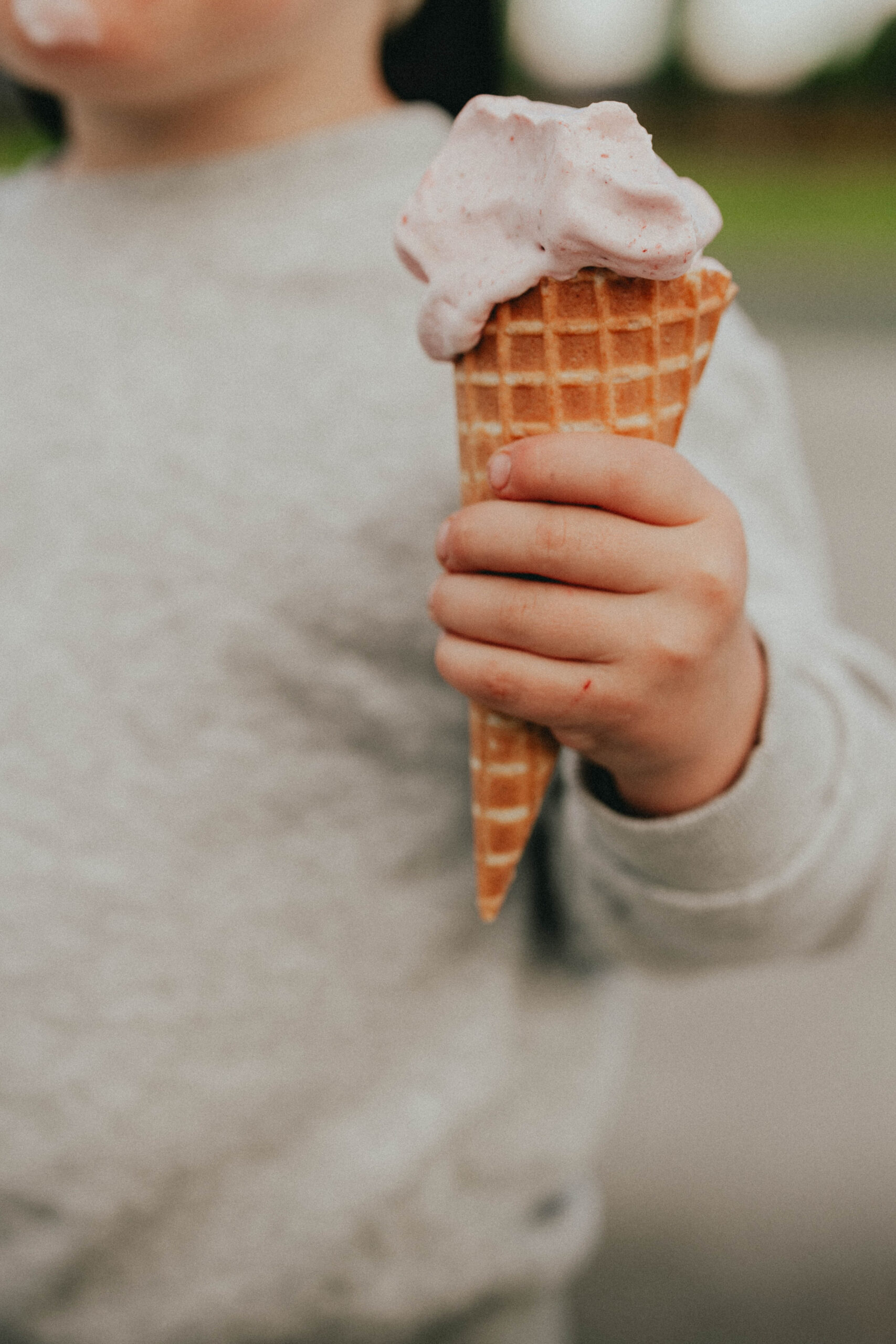 Close up family photos of a boy holding his ice cream cone