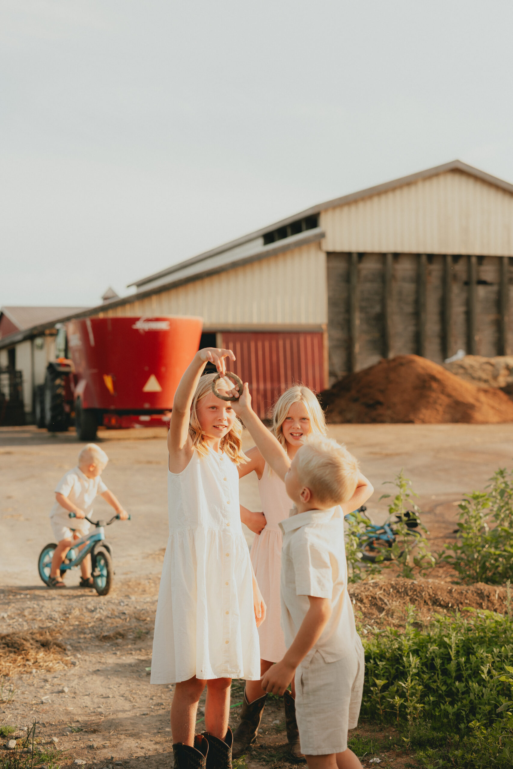 Photo of kids on their family farm playing together for a blog about abbotsford pumpkin patches