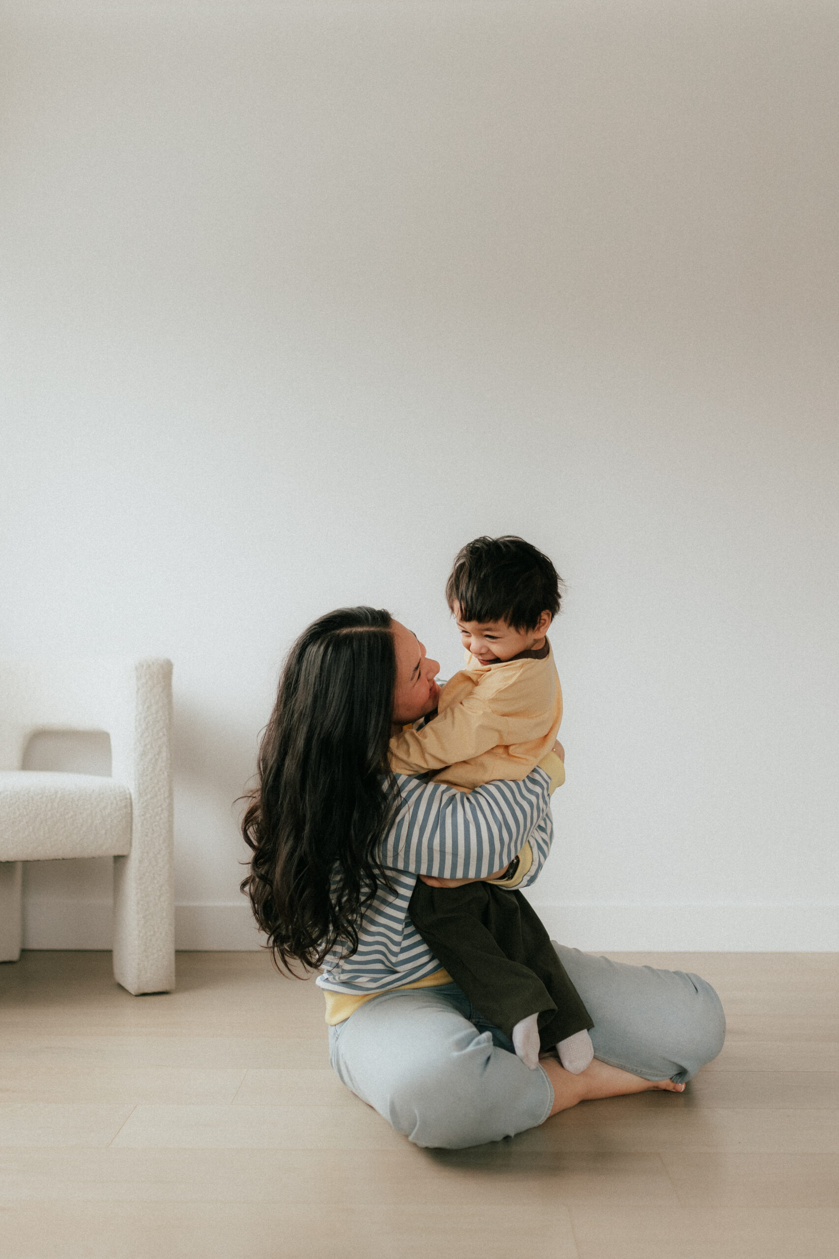 Photo of a mom holding her young son in a big hug and smiling at him for a mother's day photoshoot in abbotsford